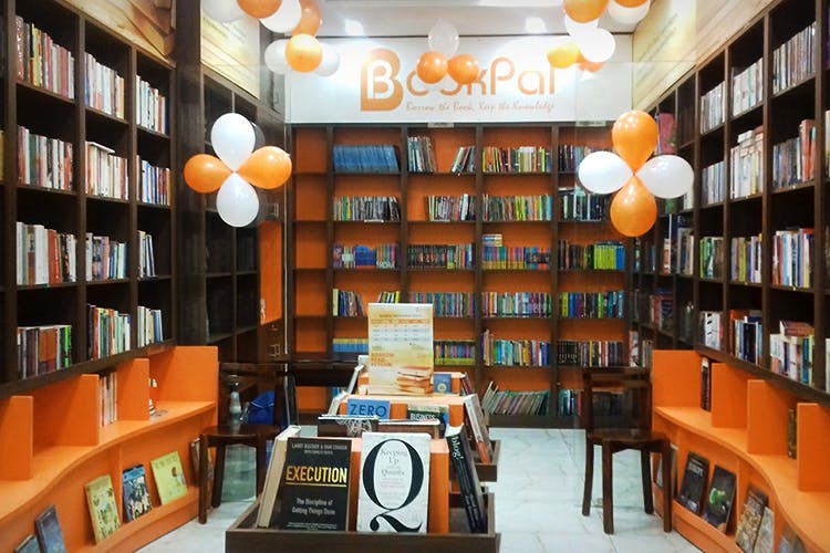 Library,Public library,Building,Bookcase,Bookselling,Shelving,Orange,Retail,Shelf,Room