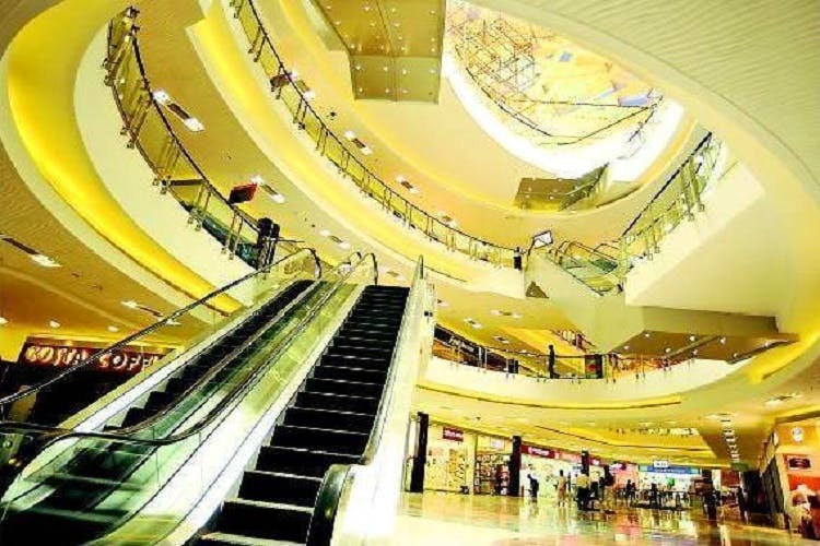 Escalator,Yellow,Shopping mall,Building,Metropolitan area,Architecture,Mixed-use,Stairs,Leisure,Metropolis