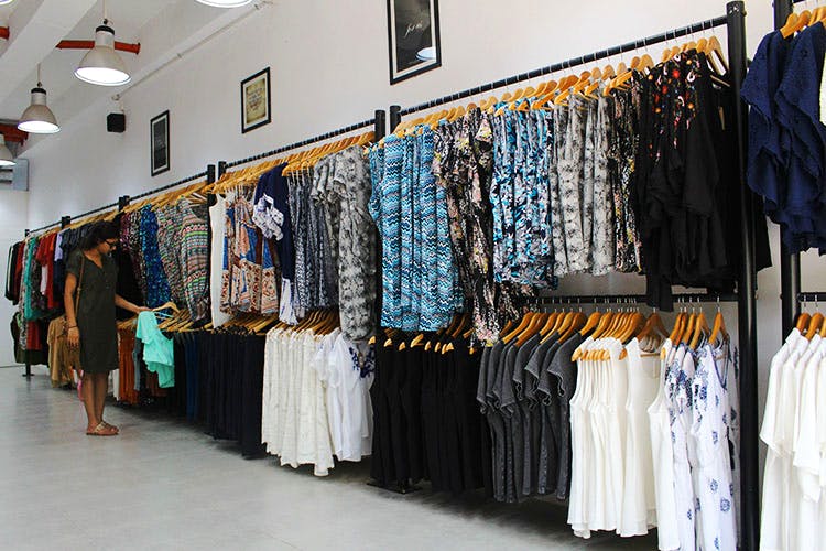 Boutique,Clothing,Room,Outlet store,Fashion,Textile,Clothes hanger,Building,Fashion design