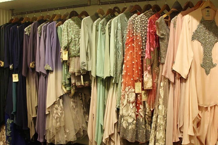 Boutique,Clothes hanger,Clothing,Room,Closet,Dress,Wardrobe,Furniture,Textile,Outerwear