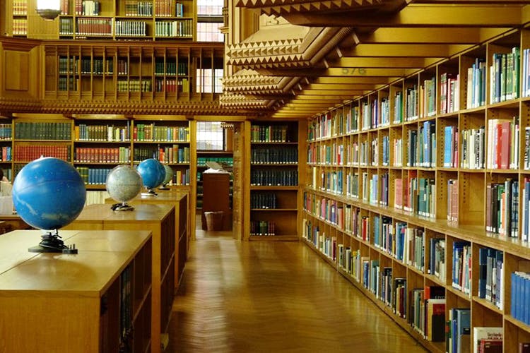 Library,Public library,Bookcase,Shelf,Shelving,Building,Book,Publication,Furniture,Architecture