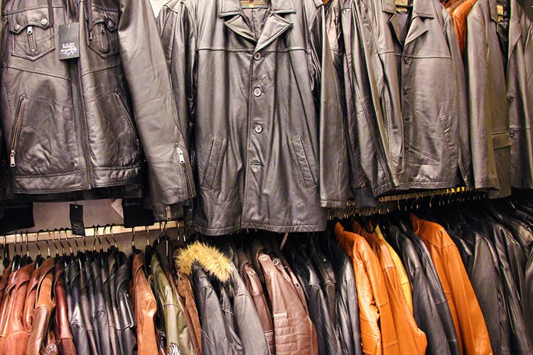 Clothing,Leather,Boutique,Clothes hanger,Jacket,Leather jacket,Textile,Footwear,Closet,Room