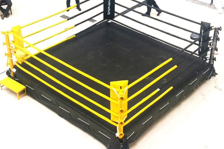 Sport venue,Boxing ring,Yellow,Furniture,Automotive exterior,Table,Metal,Stage,Bed frame,Bumper