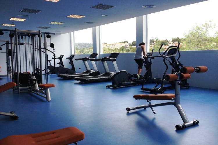 Gym,Sport venue,Room,Physical fitness,Exercise equipment,Exercise machine,Leisure centre,Bench,Crossfit,Weightlifting machine