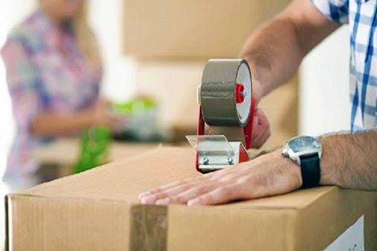 Package delivery,Box-sealing tape,Hand,Box,Table,Gadget,Carton,Furniture