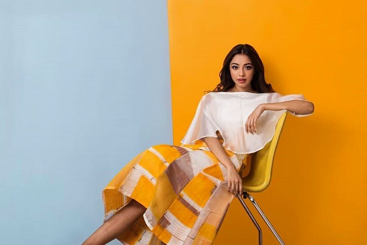 Yellow,Orange,White,Photo shoot,Shoulder,Textile,Photography,Sitting,Furniture,T-shirt