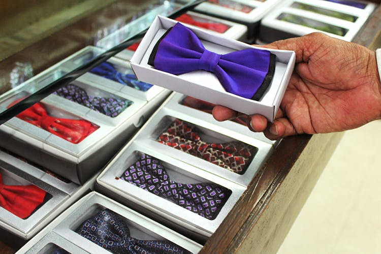 Tie,Purple,Violet,Drawer,Bow tie,Material property,Carmine,Hand,Rectangle,Textile