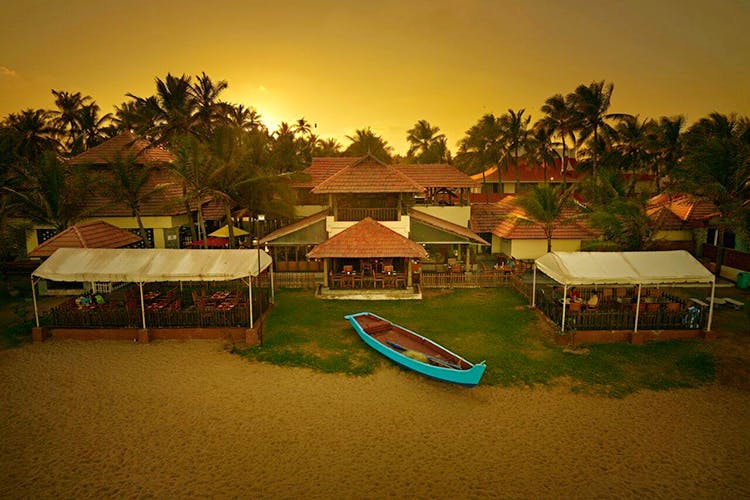 Resort,Sky,Tree,Eco hotel,Vacation,Palm tree,Tropics,House,Arecales