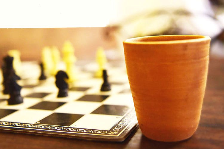 Games,Board game,Chessboard,Chess,Indoor games and sports,Yellow,Tabletop game,Recreation,Cup,Wood