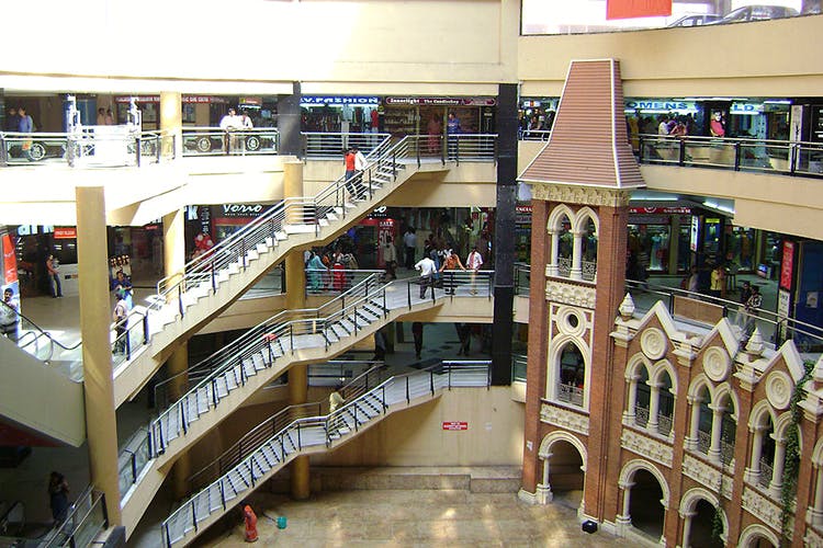 Shopping mall,Building,Retail,Architecture,Mixed-use,Stairs,Interior design,Floor,Aisle,Outlet store