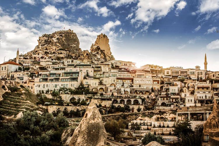 Sky,Cloud,Town,Landmark,Human settlement,Daytime,City,Ancient history,Rock,Tourism