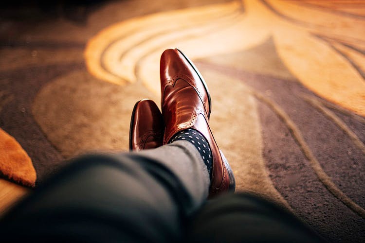 Footwear,Shoe,Light,Brown,Hand,Human leg,Leg,Sunlight,Cowboy boot,Still life photography