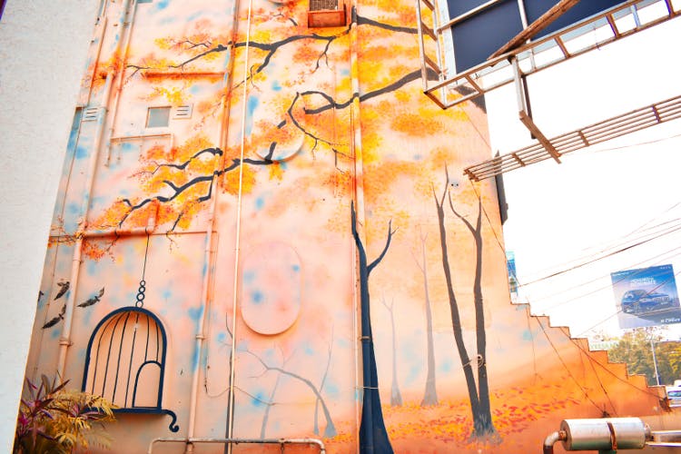 Yellow,Tree,Line,Urban area,Art,Architecture,Branch,Mural,Watercolor paint,Plant