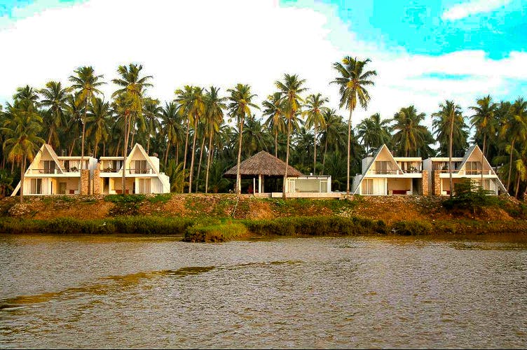 House,Home,Natural landscape,Property,Tree,River,Palm tree,Waterway,Building,Real estate