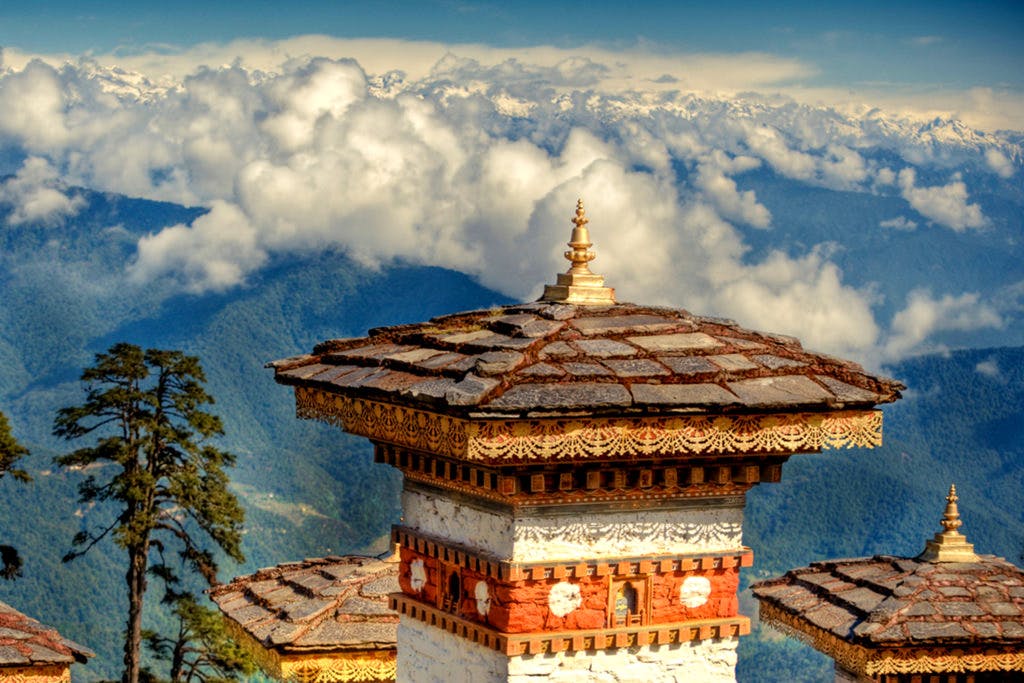 Sky,Landmark,Cloud,Architecture,Chinese architecture,Roof,Place of worship,Temple,Mountain range,Mountain