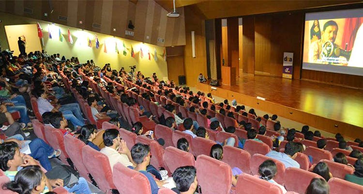 Auditorium,Audience,Event,Academic conference,Convention,Conference hall,Crowd,Seminar,Lecture,Public speaking