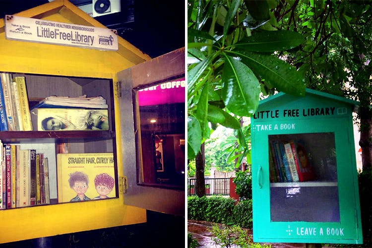 Telephone booth,Tree,Building,Architecture,House,Plant,Advertising,Facade,Display advertising,Signage