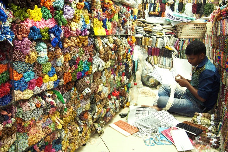 Selling,Bazaar,Marketplace,Market,Public space,Human settlement,City,Textile,Adaptation,Shopkeeper