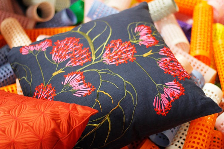 Orange,Cushion,Textile,Throw pillow,Woven fabric,Furniture,Quilting,Linens,Pillow,Pattern