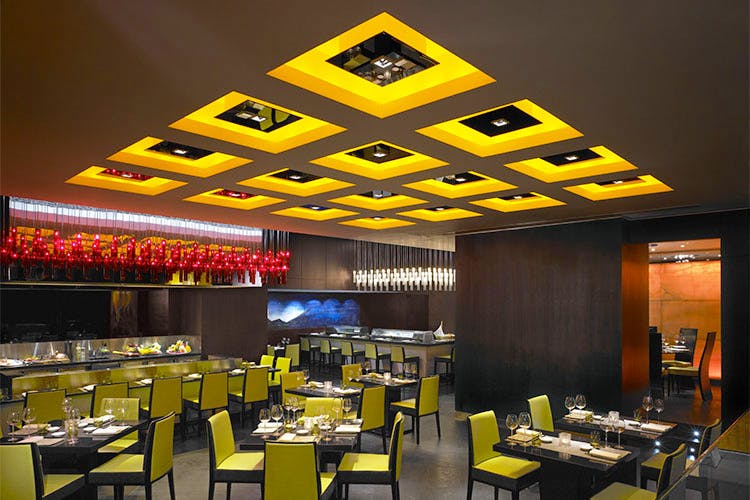 Restaurant,Yellow,Ceiling,Lighting,Building,Interior design,Fast food restaurant,Room,Architecture,Table