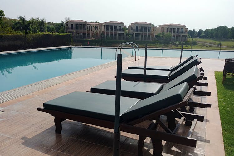Property,Furniture,Outdoor furniture,Sunlounger,Leisure,Swimming pool,Table,Resort