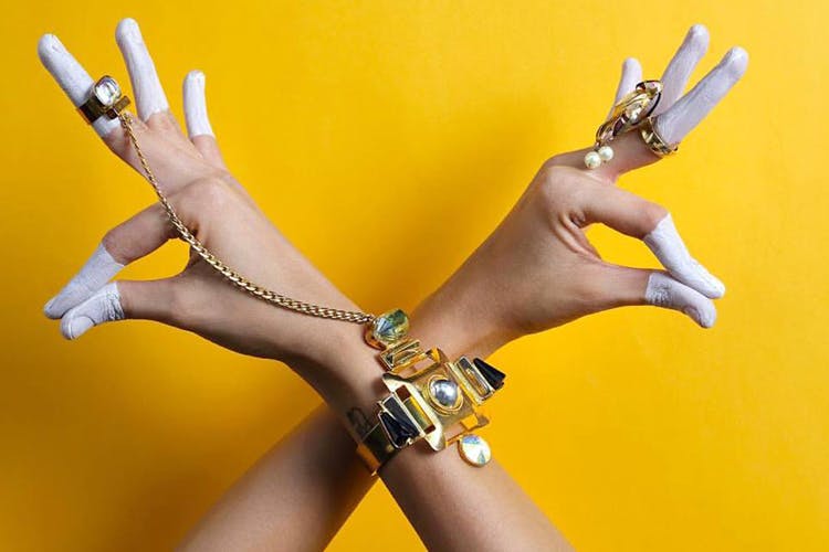 Yellow,Hand,Finger,Arm,Joint,Nail,Gesture,Fashion accessory,Metal