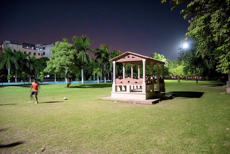 Sky,Night,Grass,Public space,Lighting,Tree,Architecture,Park,Lawn,House