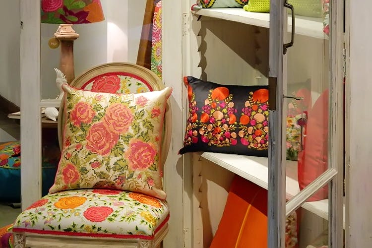 Furniture,Cushion,Room,Interior design,Textile,Chair,Plant,Couch,Floral design