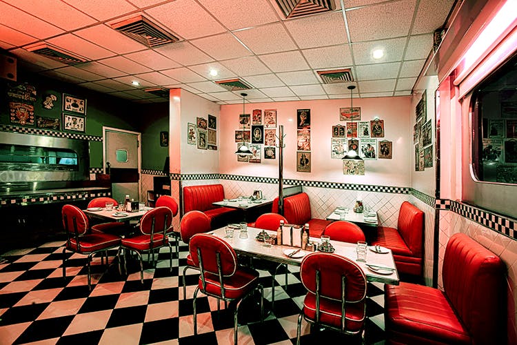 Red,Interior design,Restaurant,Building,Room,Architecture,Diner,Furniture,Table,Coffeehouse