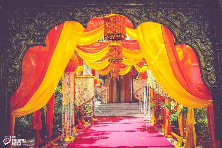 Decoration,Red,Yellow,Architecture,Textile,Arch,Place of worship,Temple,Function hall,Art