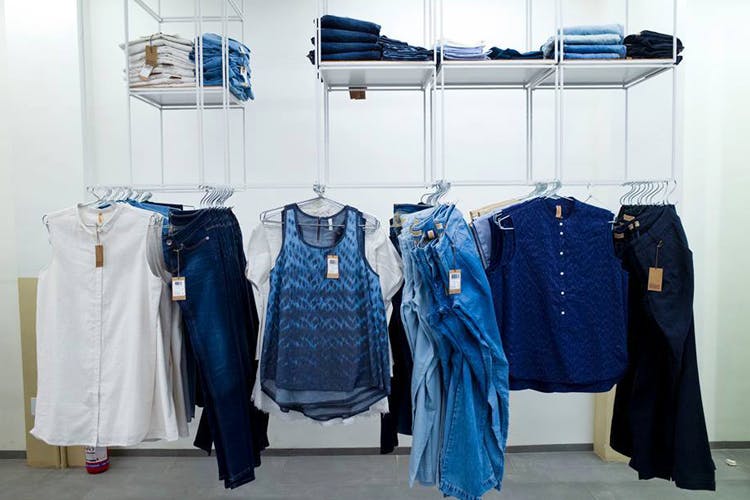 Clothes hanger,Blue,Clothing,Denim,Boutique,Jeans,Room,Textile,Outerwear,Furniture