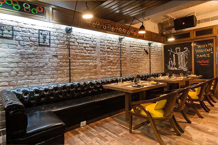 Interior design,Building,Wall,Room,Furniture,Architecture,Brick,Table,Restaurant,Bar