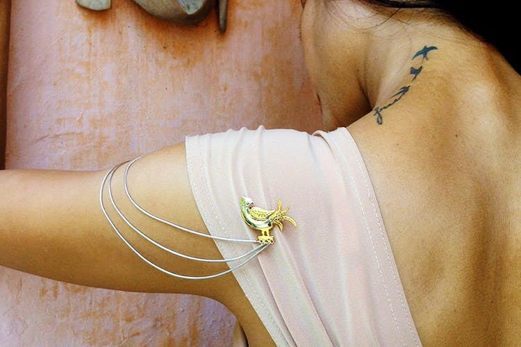 Shoulder,Arm,Yellow,Jewellery,Joint,Fashion accessory,Dress,Hand,Wrist,Neck