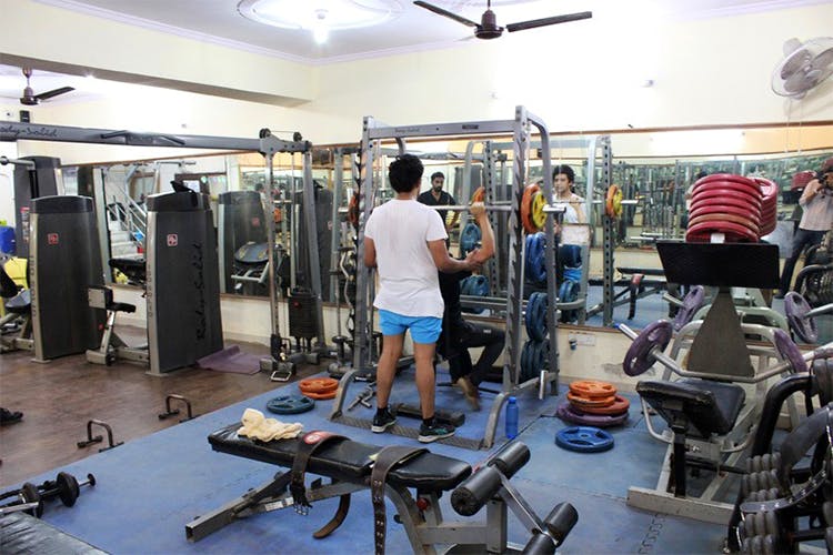 Gym,Physical fitness,Weight training,Sport venue,Room,Shoulder,Strength training,Arm,Exercise,Exercise equipment