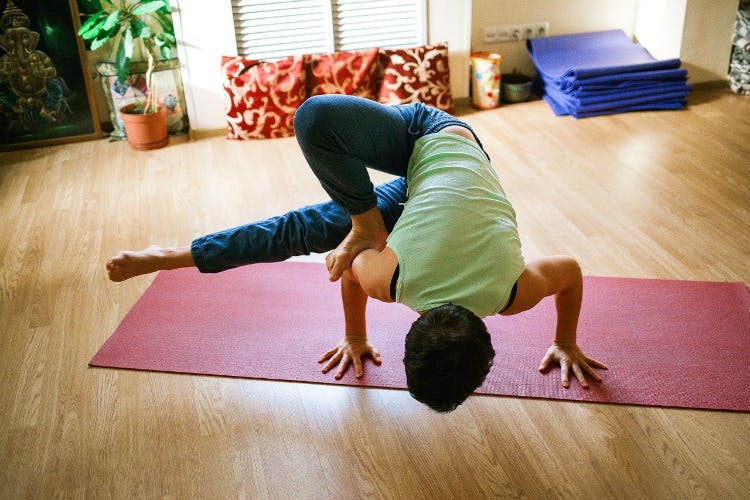 Physical fitness,Yoga,Yoga mat,Floor,Arm,Joint,Shoulder,Flooring,Exercise,Leg