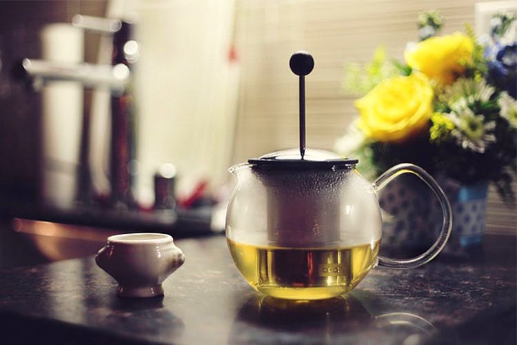 Yellow,Teapot,Chinese herb tea,Still life photography,Serveware,Kettle,Cup,Drink,Tableware,Still life