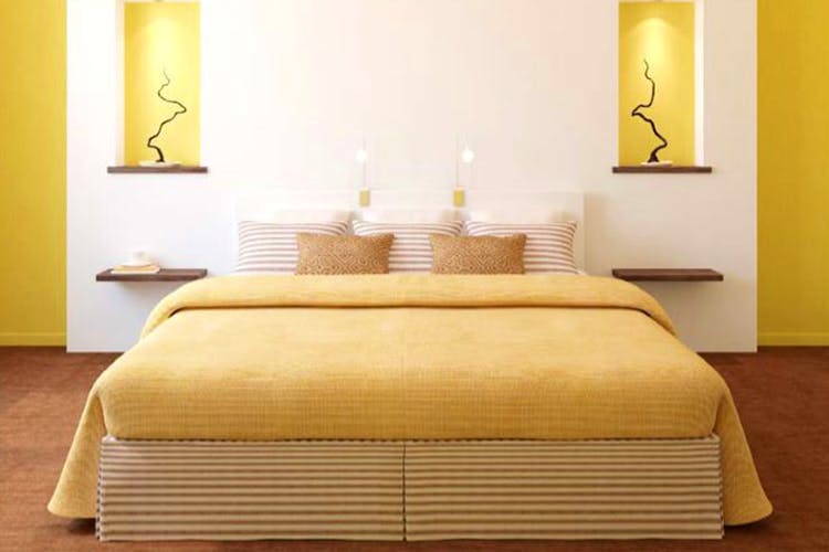 Furniture,Bed,Bedroom,Room,Bed frame,Mattress,Bed sheet,Property,Interior design,Yellow