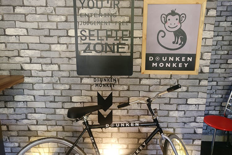 Wall,Brick,Bicycle handlebar,Bicycle,Brickwork,Street art,Art,Bicycle wheel,Photography,Bicycle accessory