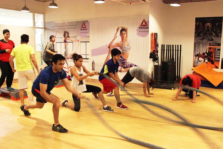 Pole acrobatics exercise for fitness in gym of training studio