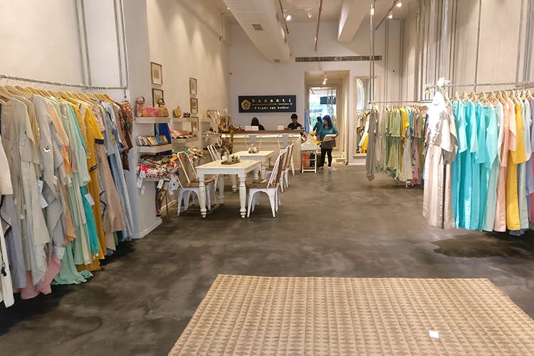 Boutique,Textile,Floor,Flooring,Room,Building,Outlet store,Aisle,Retail,Interior design