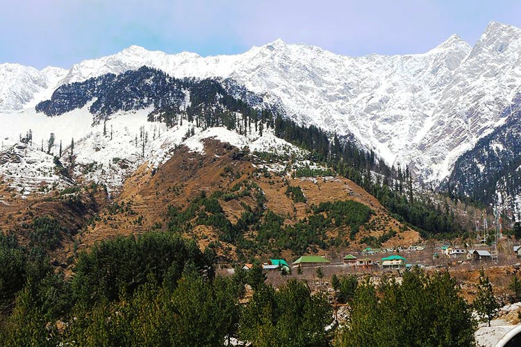 Mountainous landforms,Mountain,Mountain range,Hill station,Mountain village,Sky,Hill,Highland,Natural landscape,Alps