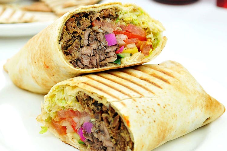 Dish,Food,Cuisine,Sandwich wrap,Ingredient,Mission burrito,Shawarma,Produce,Burrito,Street food