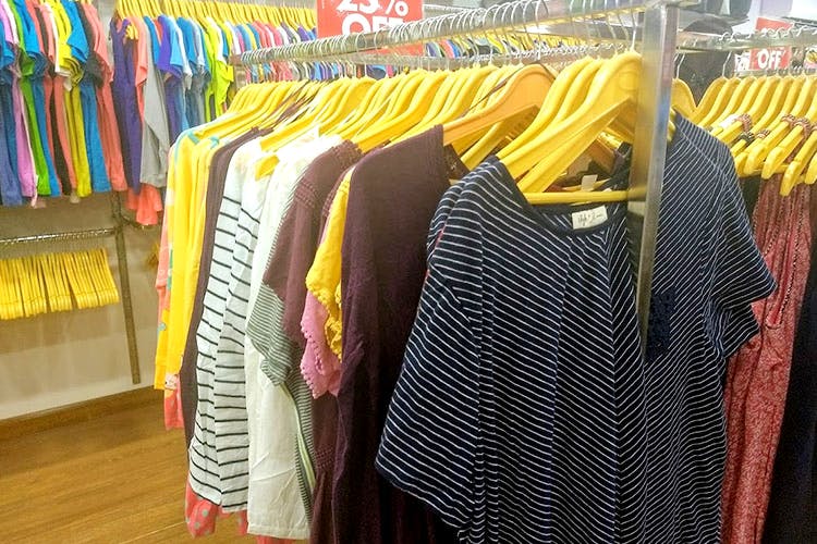 Clothing,Clothes hanger,Boutique,Yellow,Bazaar,Room,Outlet store,Textile,Closet,Outerwear