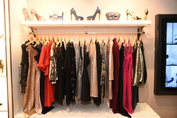 Boutique,Closet,Room,Clothes hanger,Shelf,Furniture,Wardrobe,Shelving,Outerwear,Dress