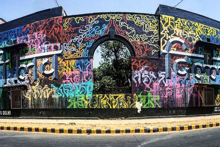 Graffiti,Street art,Wall,Mural,Urban area,Art,Architecture,Sky,Facade,Tree