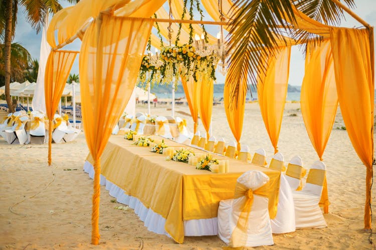 Decoration,Yellow,Orange,Furniture,Canopy,Function hall,Ceremony,Table,Architecture,Aisle