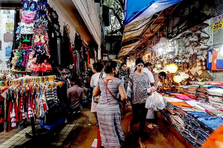 Bazaar,Market,Marketplace,Selling,Public space,Human settlement,City,Shopping,Textile,Retail