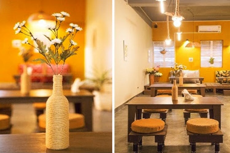 Yellow,Interior design,Room,Restaurant,Table,Building,Furniture,Vase,Brunch,Plant