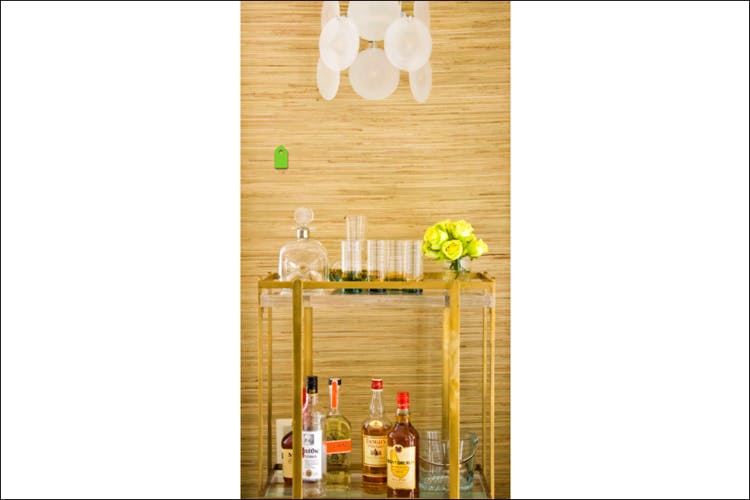 Yellow,Wine bottle,Table,Furniture,Bottle,Room,Interior design,Glass bottle,Wood,Glass