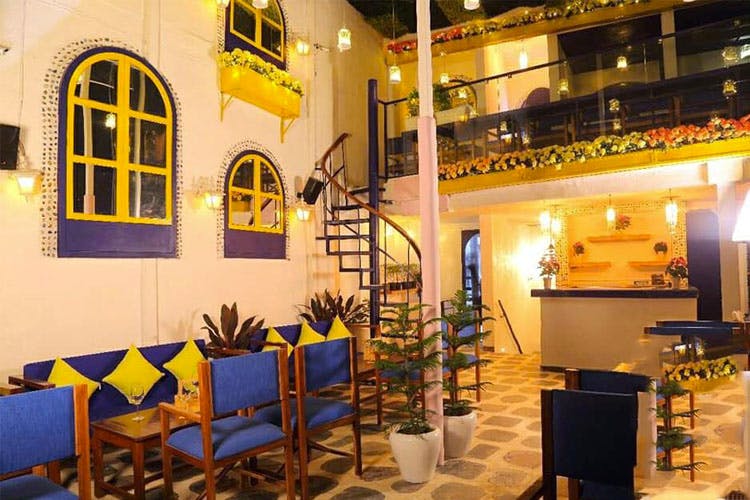 Restaurant,Yellow,Building,Interior design,Room,Architecture,Table,Café,Furniture,Coffeehouse